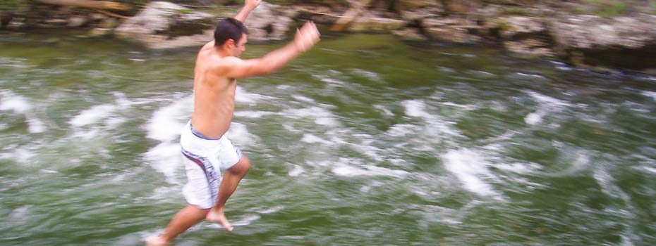 man jumping into selway river in idaho