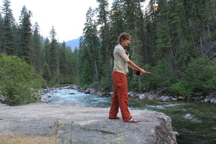 woman fly fishing a river