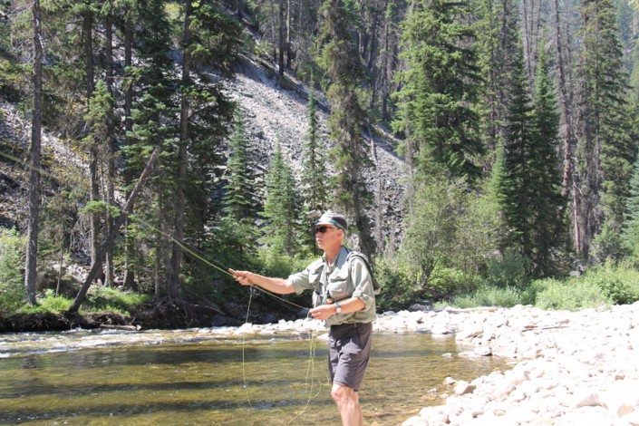 fly fisherman casting into selway river in the idaho wilderness