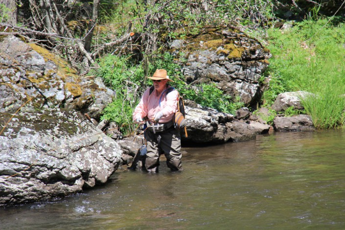 fly fisherman casting on selway river, idaho wilderness